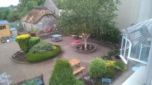 an aerial view of a garden with a bench and a building at The Townhouse in Elphin