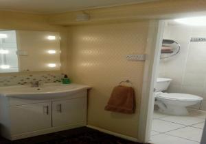 a bathroom with a sink and a toilet at Number One Guesthouse in Dover