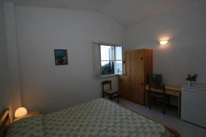 Postel nebo postele na pokoji v ubytování Hotel Club Poseidon
