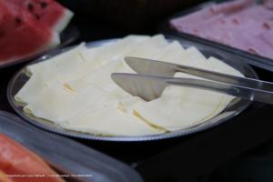 a plate of food with a plate of cheese at Hotel Princeton in Piracicaba