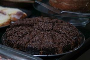 a chocolate cake on a plate with other pastries at Hotel Princeton in Piracicaba