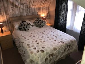 a bedroom with a white bed with pillows on it at West Vale Villa in Blackpool