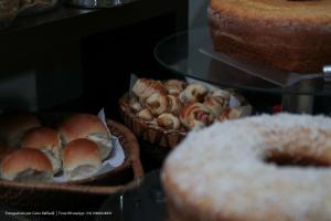 two baskets of bread and pastries on display in a bakery at Hotel Princeton in Piracicaba