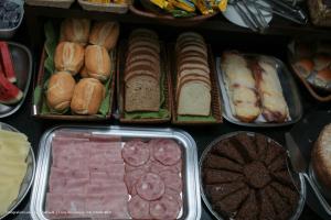 a bunch of different types of food in trays at Hotel Princeton in Piracicaba