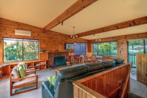a living room with a couch and a fireplace at Beachcroft in Coles Bay