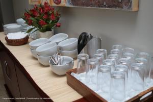 a wooden counter with glasses and dishes on it at Hotel Princeton in Piracicaba