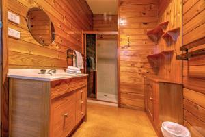 a bathroom with wooden walls and a sink and a shower at Beachcroft in Coles Bay +14 photos