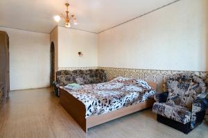 a bedroom with a bed and a chair at Like A Home in Sumy
