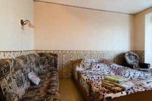 a room with a bed and a couch in it at Like A Home in Sumy +3 photos