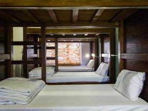 two bunk beds in a room with a window at Micasa Hostels in Puducherry