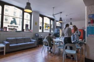a group of people sitting at a table in a restaurant at Ashfield Hostel in Dublin