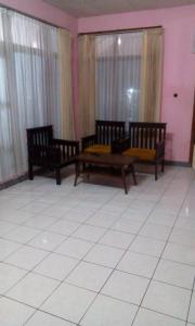 a room with three wooden benches and windows at Pondok Stevia Ciwidey in Ciwidey