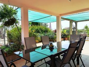 a glass table and chairs on a patio at Finca Sa Gruta Marines in S'Illot
