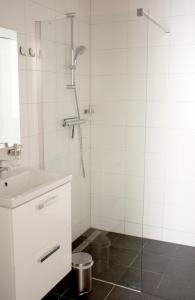 a bathroom with a sink, toilet and shower stall at ApartHotel Waepen van Middelburg in Middelburg