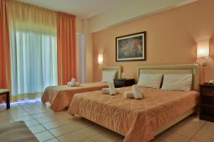 Posteľ alebo postele v izbe v ubytovaní Hotel Ilion