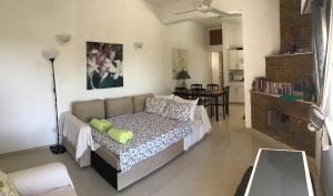 a living room with a bed and a couch at Orchard View Cottage in Maroni