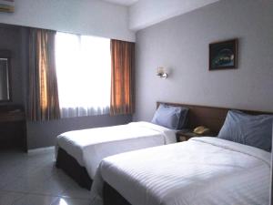 Postel nebo postele na pokoji v ubytování K-Style Eco Hotel Jakarta
