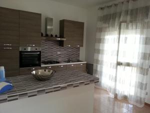 a kitchen with a counter with a bowl on it at Villa Fiorella in Sciacca