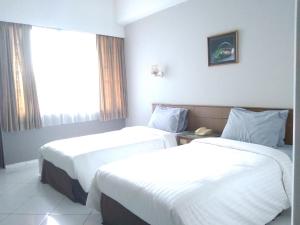 Postel nebo postele na pokoji v ubytování K-Style Eco Hotel Jakarta
