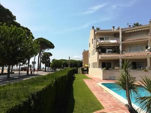 a house with a swimming pool in front of it at Apartamentos la Dorada in Cambrils