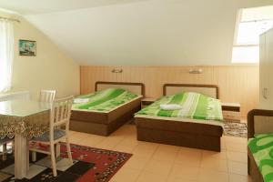 a bedroom with two beds and a table and a table at Willa Mewa in Gdynia