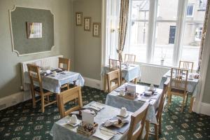 une salle à manger avec deux tables et une fenêtre dans l'établissement Hazeldene Guest House, à Perth