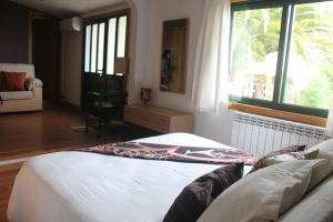 a bedroom with a bed and a window at Casa Spa en montaña in Pontevedra