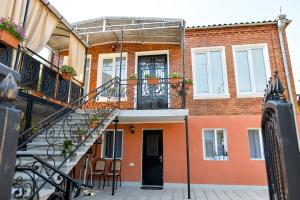 a building with a staircase in front of it at Bibi in Kutaisi