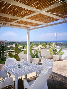 a table and chairs on a patio with a view at Casa Vacanze Fiore in Gallipoli