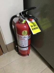 a red fire hydrant with a tag on it at Palm Tree Villas 2 in Manila