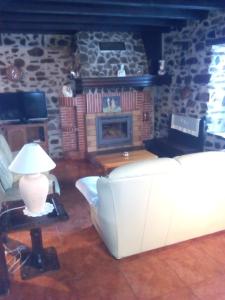 a living room with a couch and a fireplace at Casa Manuelena in Valcarlos