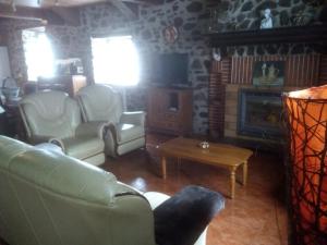 a living room with a couch and a fireplace at Casa Manuelena in Valcarlos