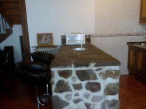 a room with a stone counter with two chairs at Casa Manuelena in Valcarlos +19 photos