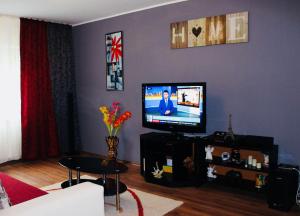 a living room with a flat screen tv on a wall at 3-Room Delta Modern Residence in Tulcea +7 photos
