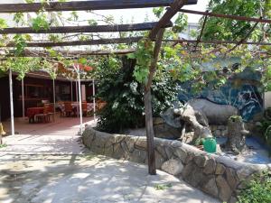 a garden with a stone wall and a pergola at byala kısta apart in Isperikh