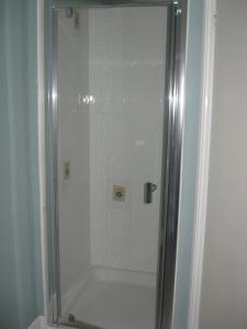a shower with a glass door in a bathroom at Eastbourne Reymar in Eastbourne +166 photos