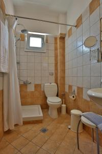 a bathroom with a toilet and a sink at Hotel Ilion in Paralia Katerinis