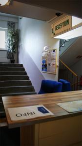 a room with stairs and a table with a sign on it at Citimotel in Lappeenranta