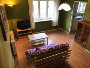 a living room with a couch and a table and a television at Flat 9a Badby Close in Manchester