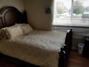 a bed in a bedroom with a large window at 500/502 W 23rd St in Cheyenne