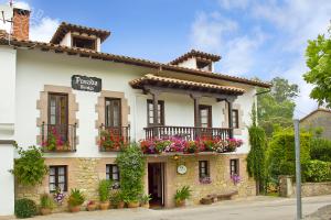 un edificio con cajas de flores en la parte delantera en Posada Revolgo, en Santillana del Mar