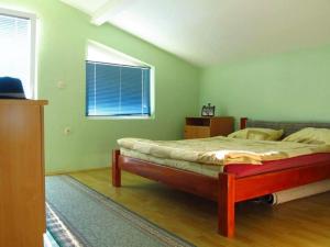 a bedroom with a large bed with a window at Villa Two Brothers in Ohrid
