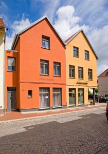 a large orange building on a street at Appartment Haus Sandra in Waren