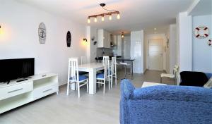 a living room with a blue couch and a dining room at Bacana 9-4 in Benidorm