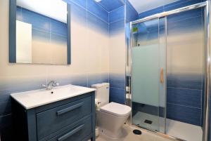 a bathroom with a toilet and a sink and a shower at Bacana 9-4 in Benidorm +17 photos