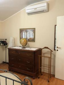 a room with a wooden dresser and a fan at La Romantica in Lanciano