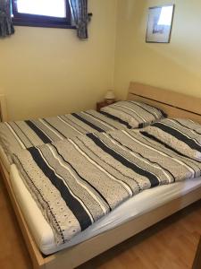 a bed with two pillows on it in a bedroom at Appartementhaus Karawankenpromenade in Velden am Wörthersee