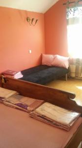 a bedroom with a wooden bed in a room at Къща за гости Пеневи in Sofia