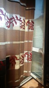 a window with a curtain with red writing on it at Къща за гости Пеневи in Sofia