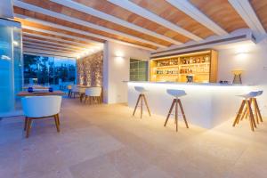 a tasting room with a bar with stools at Agroturismo Can Toni Xumeu - Adults Only in Cala Llonga